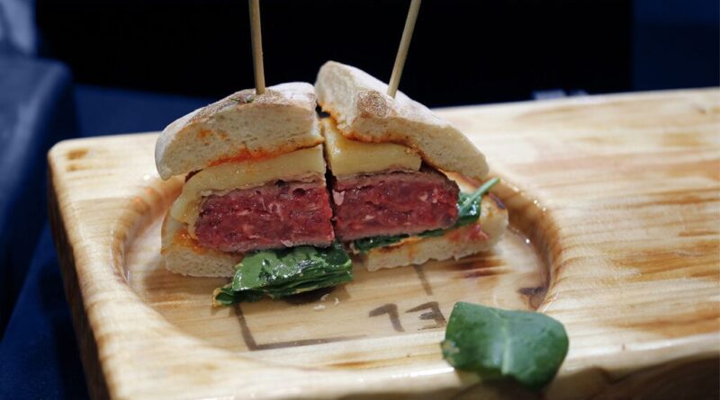 Two quarters of cheese and beef burger side by side, held together by each toothpick
